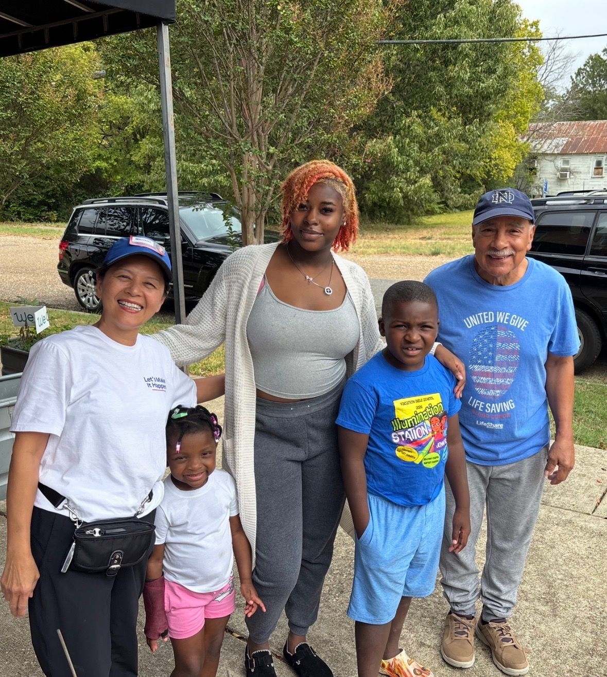 Hanh Williams in a blue campaign cap with Allendale neighbors, including two children, at a community meet and greet in Shreveport, October 3, 2026