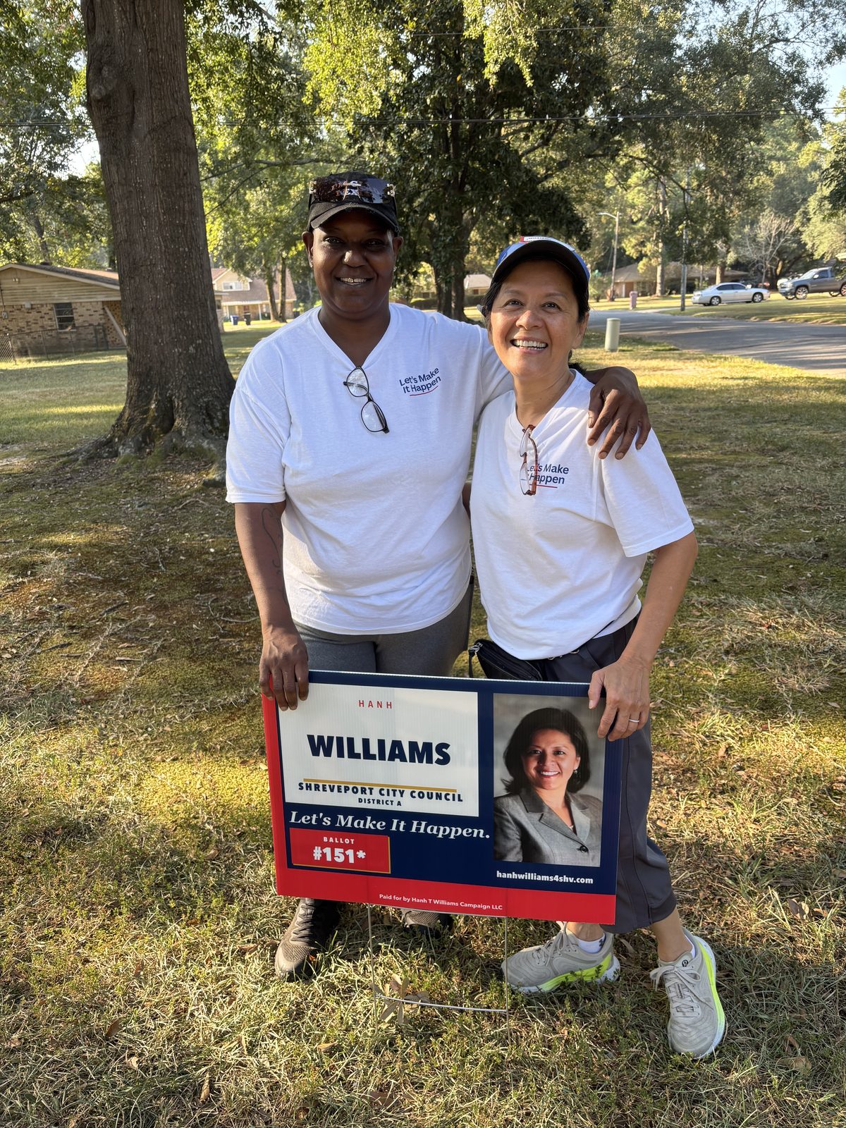 Hanh Williams and a campaign volunteer in matching campaign shirts with a Hanh Williams yard sign while out walking District A, September 29, 2026
