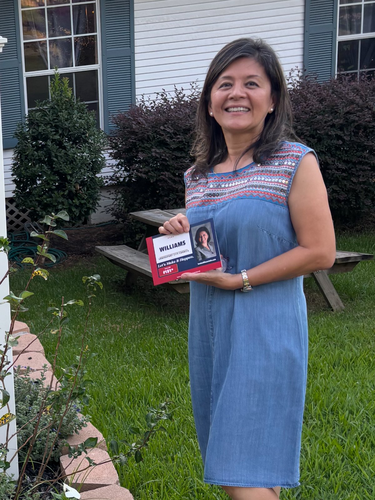 Hanh Williams canvassing door to door in the Lakeside neighborhood of Shreveport, holding a campaign card, September 15, 2026