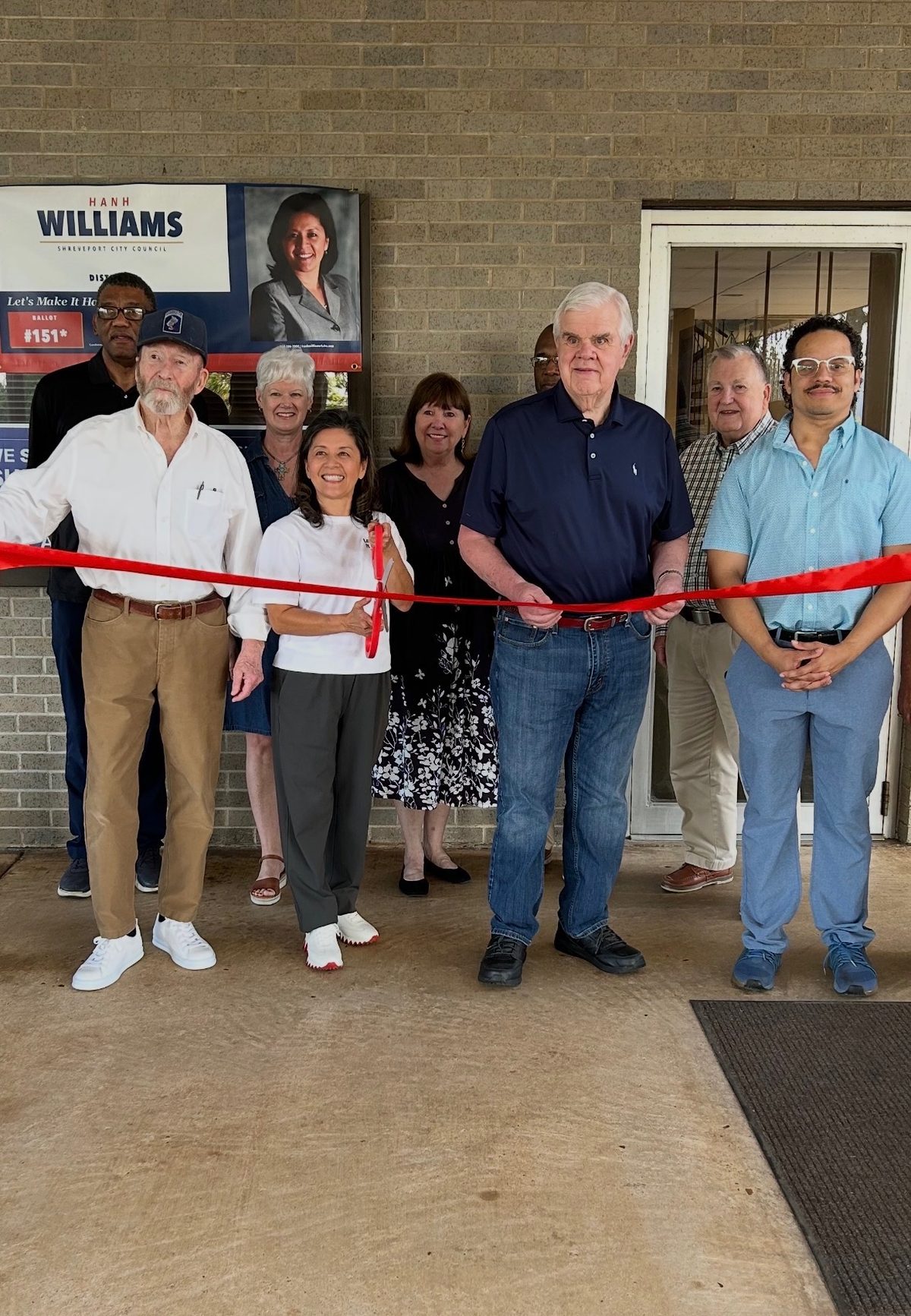 Hanh Williams cutting the ribbon at her campaign headquarters, 1500 N Market St, with Foster Campbell and supporters, September 28, 2026